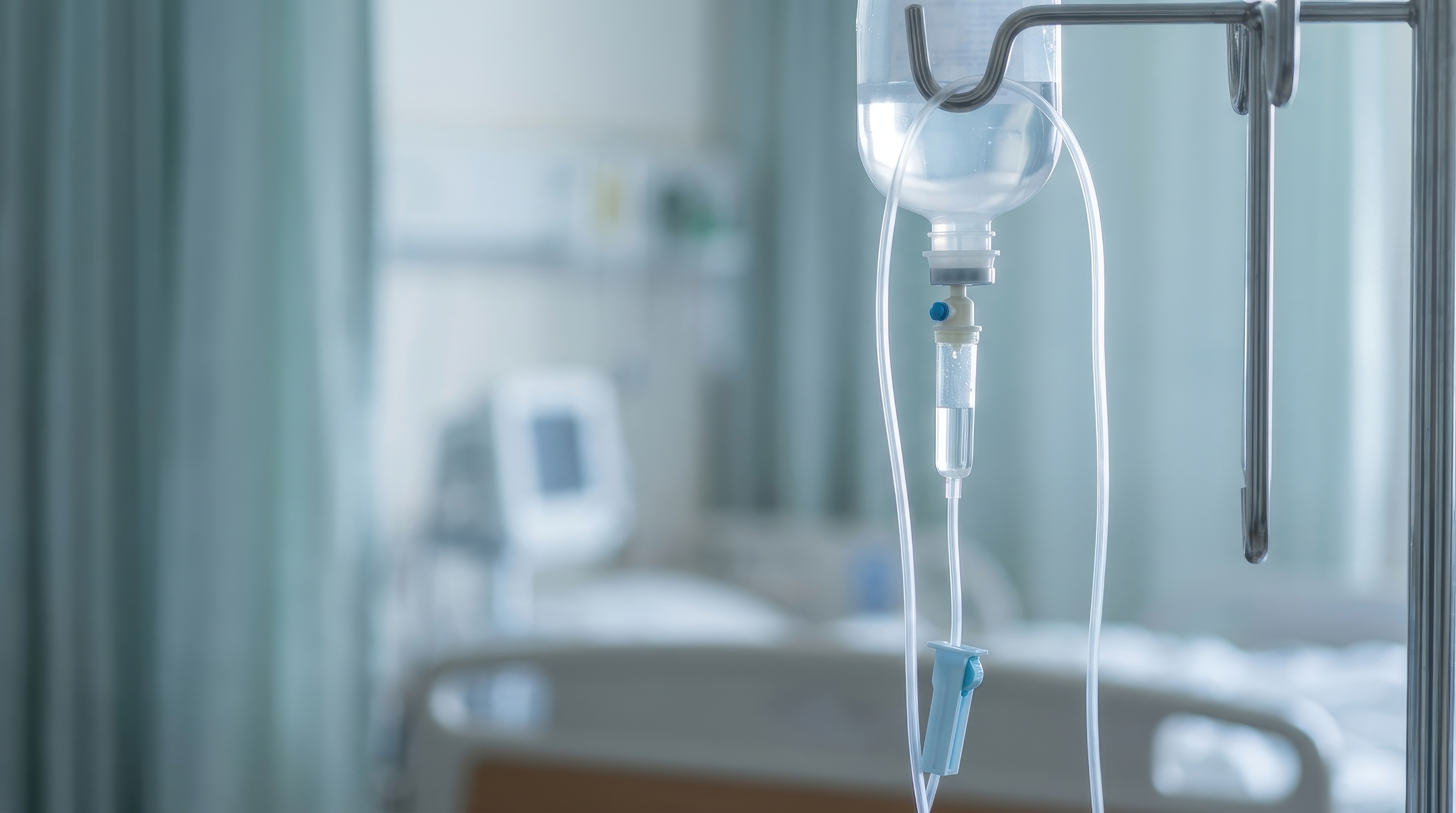 IV drip hanging beside a hospital bed